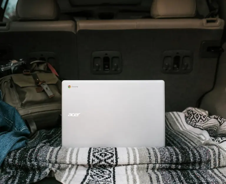 Digital Advertiser Nomad Lifestyle: A laptop, passport, and world map symbolizing the blend of digital advertising expertise with location independence.